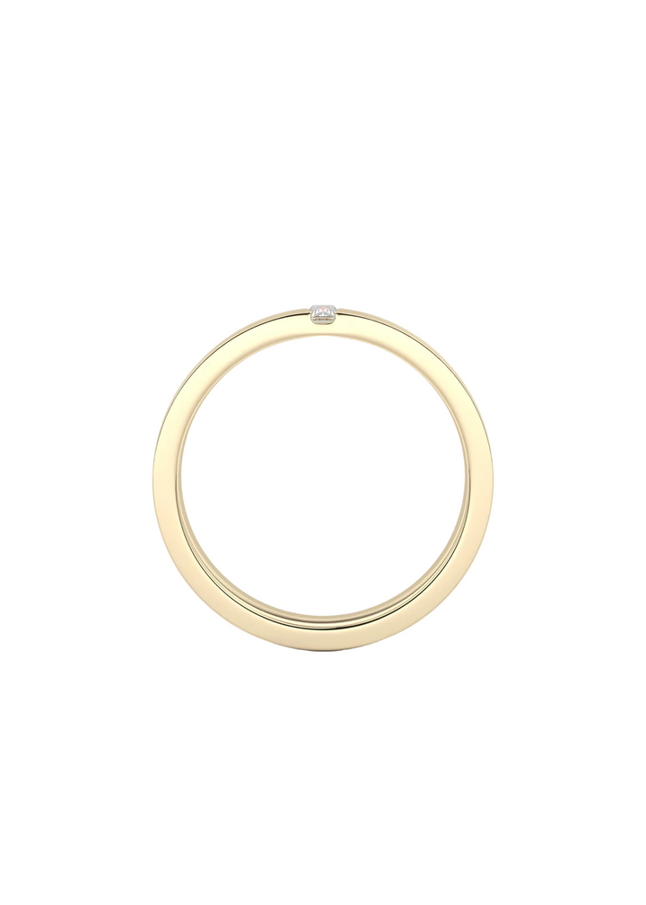 A minimalist gold ring with a single small clear gemstone set at the top, shown against a clean white background.