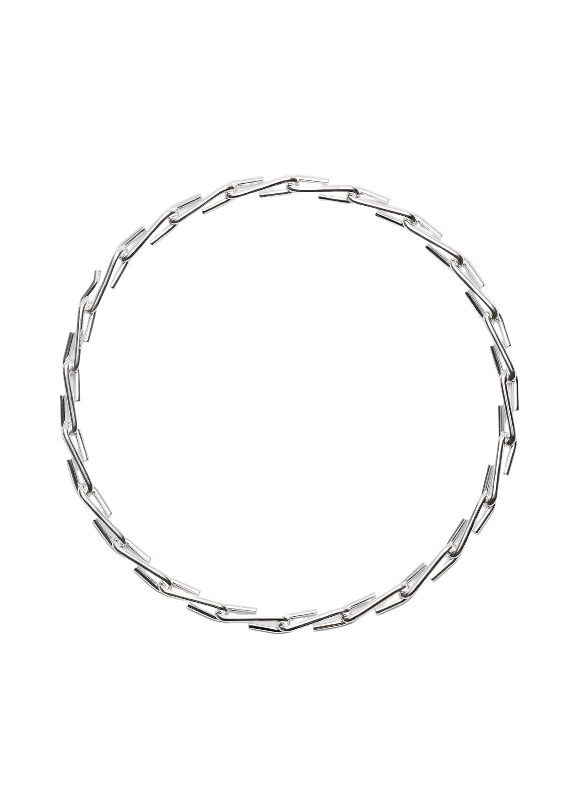 A silver-toned geometric chain necklace with elongated, angular links arranged in a circular shape, photographed against a clean, light gray background.
