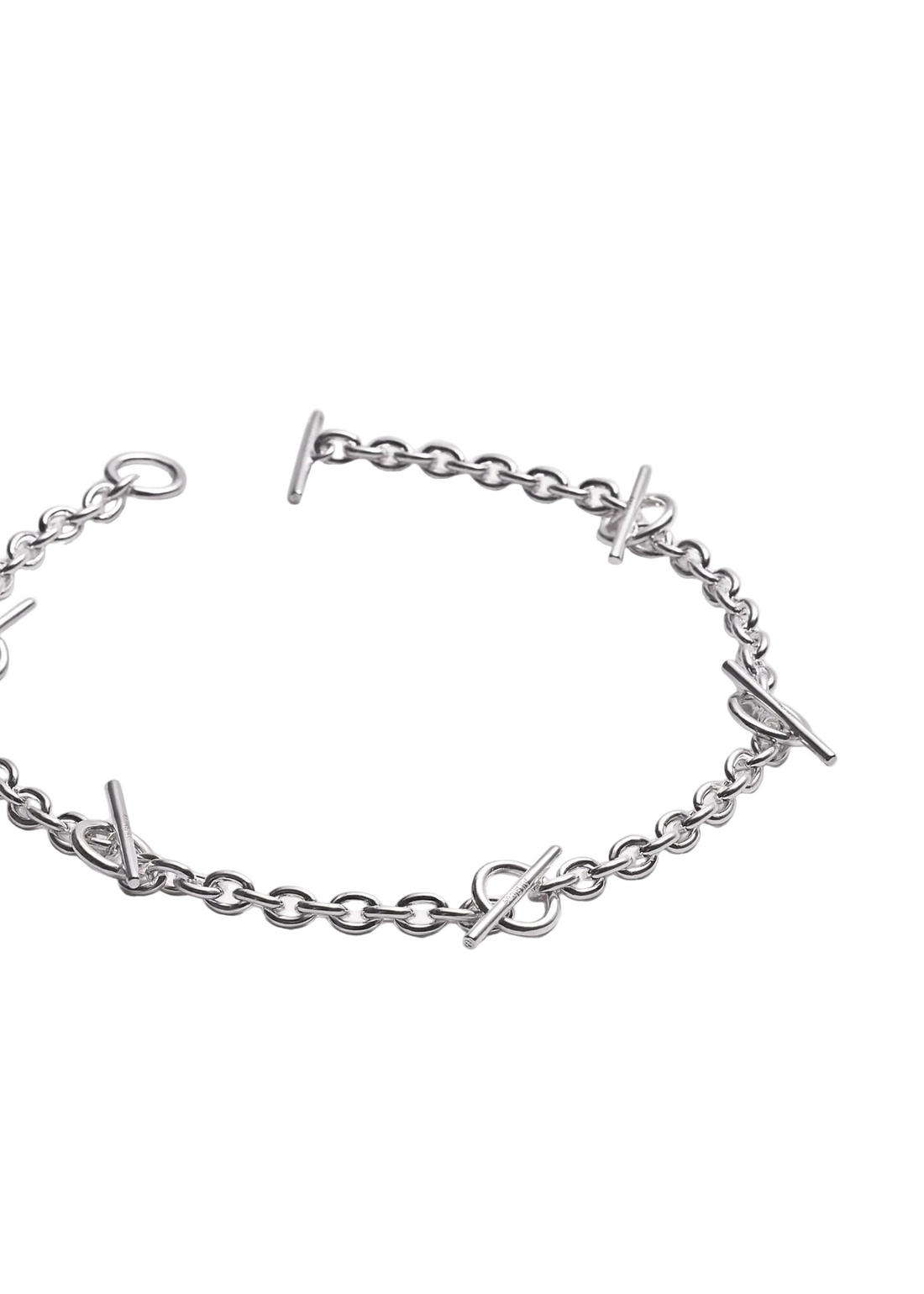 A silver chain bracelet featuring interlocking bar links and small stylized letter charms, displayed on a clean white background.