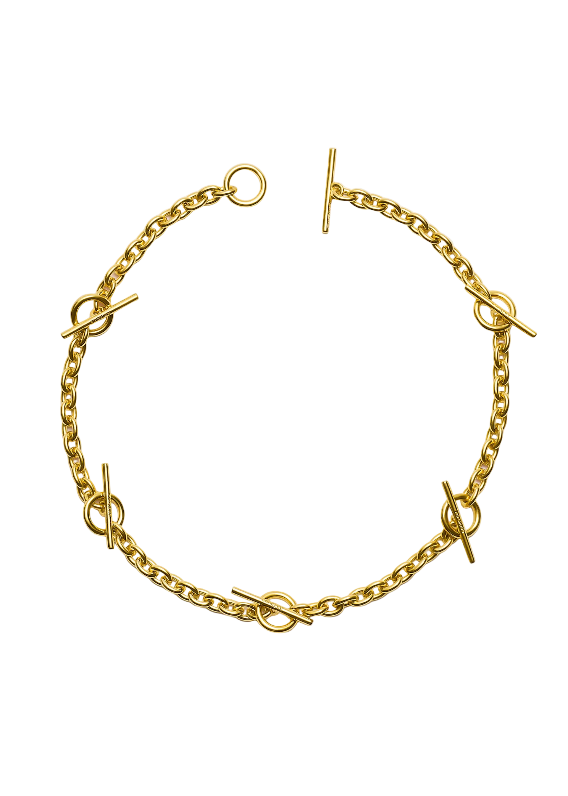 A gold chain bracelet with circular links and toggle clasp closures, photographed flat on a light gray background.