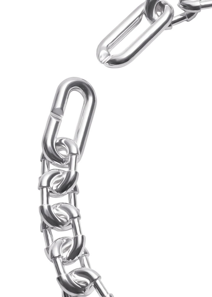 Close-up of a polished silver metal chain with interlocking oval links and a large lobster clasp, photographed on a clean white background.