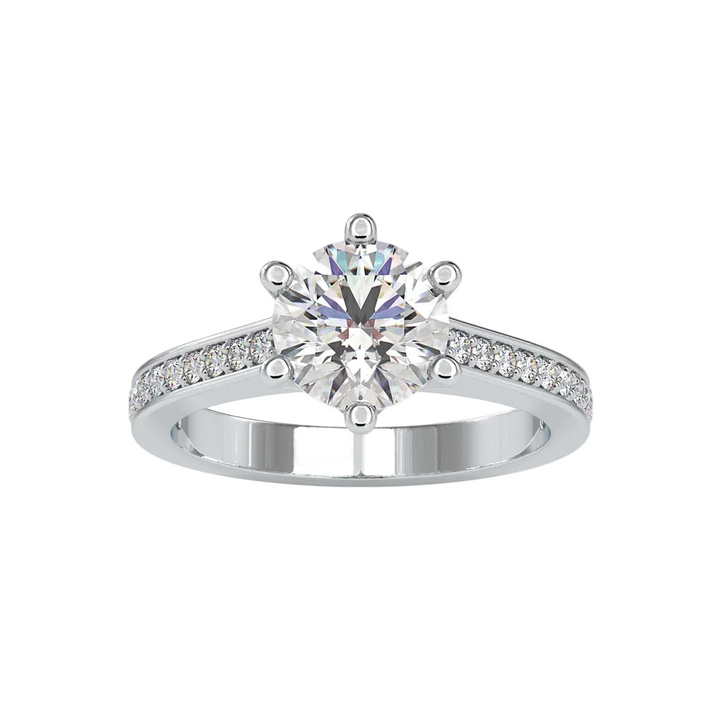 A silver-tone solitaire engagement ring featuring a round brilliant-cut clear center stone and a pavé-set band, shown on a plain white background.