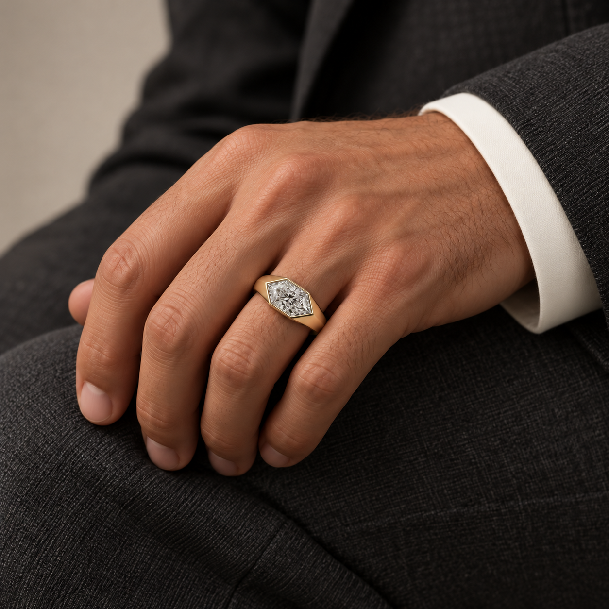Man wearing the elongated hexagon lab-grown diamond signet ring in yellow gold