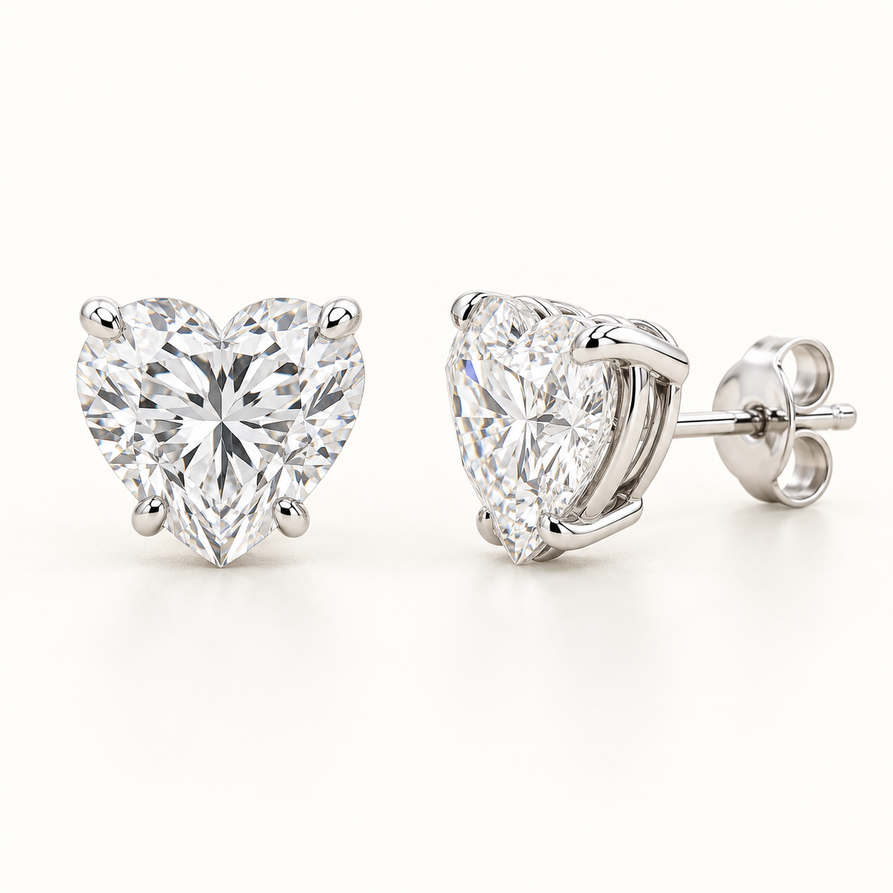 Heart-cut lab-grown diamond stud earrings, front and side views